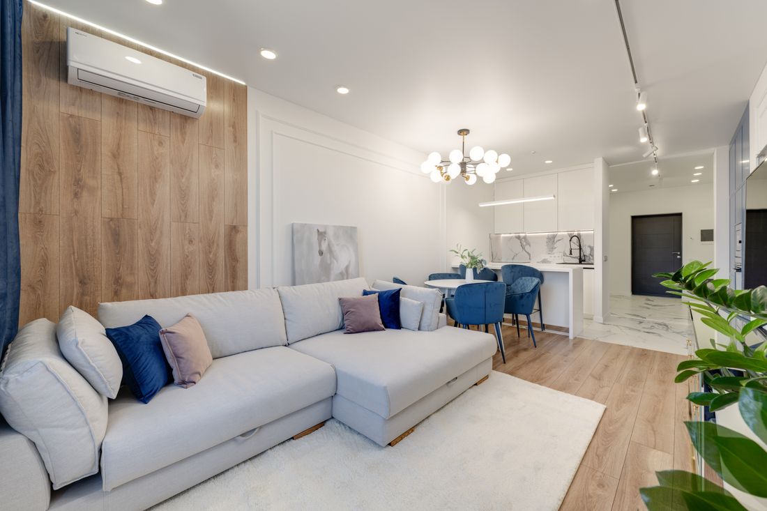 Wall-mounted air conditioning unit in a comfortable living room