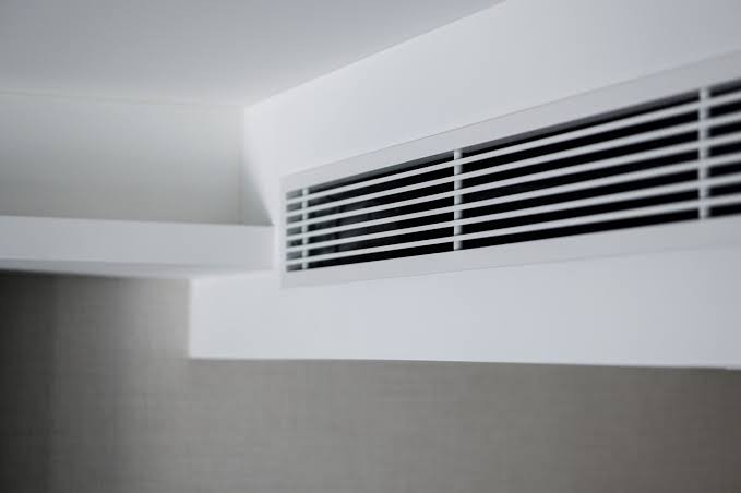 Slim concealed ducted air conditioning grille set into a ceiling