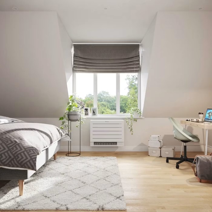 Low wall-mounted console air conditioning unit fitted under a bedroom window